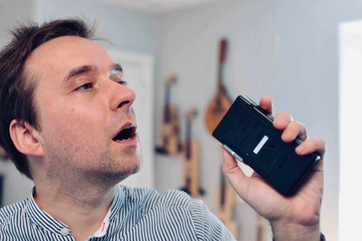 Dave singing into a microcassette recorder